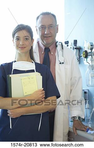 Portrait of a female nurse and a male doctor smiling View Large Photo Image Stock Image - Portrait of a female nurse and a male doctor smiling. Fotosearch