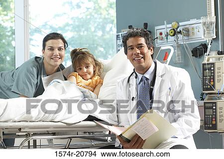 Portrait of a girl with a female nurse and a male doctor smiling View Large Photo Image Picture - Portrait of a girl with a female nurse and a male doctor smiling. Fotosearch