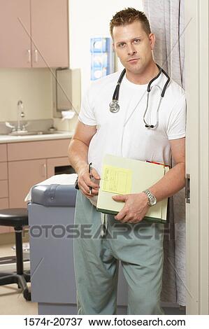 Portrait of a male doctor leaning against a door View Large Photo Image Stock Photo - Portrait of a male doctor leaning against a door. Fotosearch