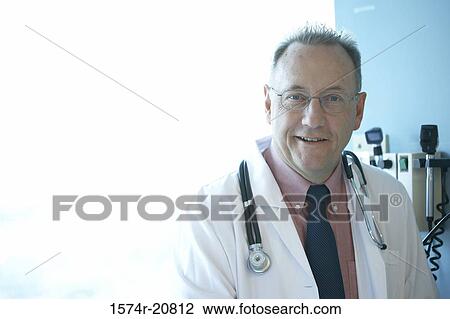 Stock Image - Portrait of a male doctor smiling with a stethoscope around his neck. Fotosearch