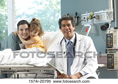 Portrait of a male doctor smiling with a girl hugging a nurse View Large Photo Image Stock Photography - Portrait of a male doctor smiling with a girl hugging a nurse. Fotosearch