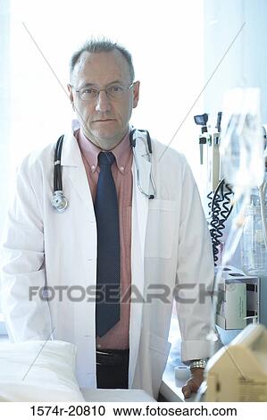Portrait of a male doctor with a stethoscope around his neck View Large Photo Image Stock Image - Portrait of a male doctor with a stethoscope around his neck. Fotosearch