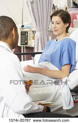 Rear view of a male doctor examining a female patient View Large Photo Image Stock Photo - Rear view of a male doctor examining a female patient. Fotosearch
