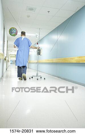 Rear view of a male patient walking with an IV drip stand View Large Photo Image Stock Image - Rear view of a male patient walking with an IV drip stand. Fotosearch
