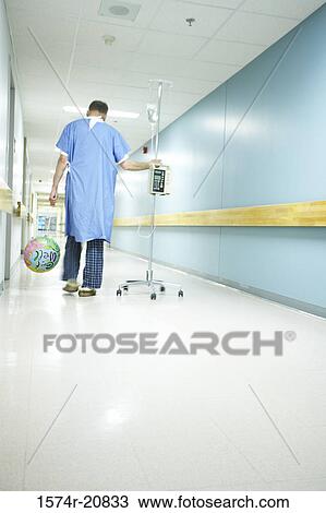 Rear view of a male patient walking with an IV drip stand View Large Photo Image Stock Image - Rear view of a male patient walking with an IV drip stand. Fotosearch