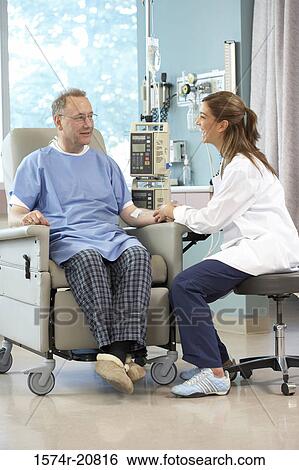 Side profile of a female doctor examining a male patient View Large Photo Image Stock Photograph - Side profile of a female doctor examining a male patient. Fotosearch