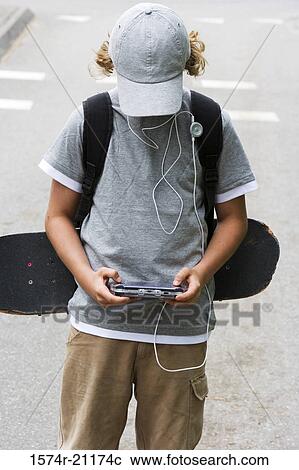 Close-up of a boy playing a video game View Large Photo Image Stock Image - Close-up of a boy playing a video game. Fotosearch