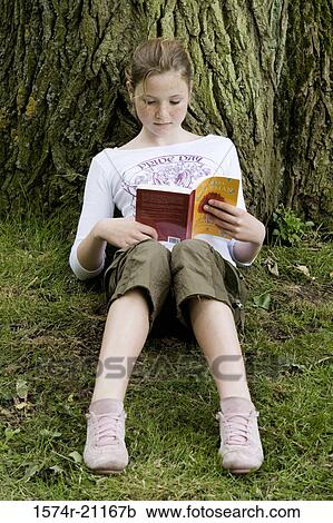 Close-up of a girl reading a book View Large Photo Image Stock Image - Close-up of a girl reading a book. Fotosearch