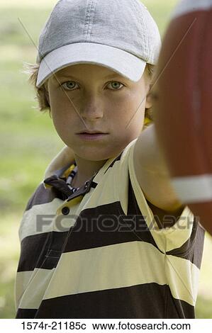 Portrait of a boy holding a football View Large Photo Image Stock Image - Portrait of a boy holding a football. Fotosearch