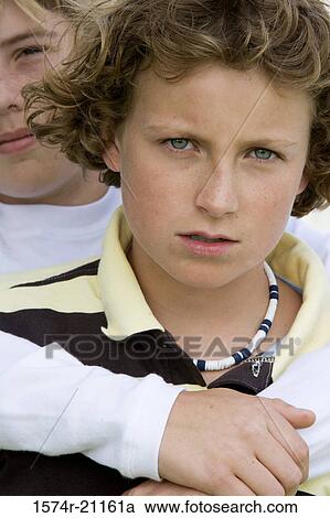 Portrait of a boy hugging another boy from behind View Large Photo Image Stock Image - Portrait of a boy hugging another boy from behind. Fotosearch