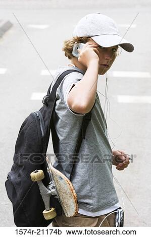 Portrait of a boy using a mobile phone View Large Photo Image Stock Image - Portrait of a boy using a mobile phone. Fotosearch