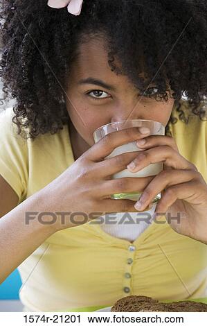 Portrait of a girl drinking milk View Large Photo Image Stock Image - Portrait of a girl drinking milk. Fotosearch