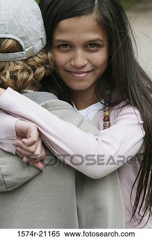 Portrait of a girl hugging a boy View Large Photo Image Stock Photography - Portrait of a girl hugging a boy. Fotosearch