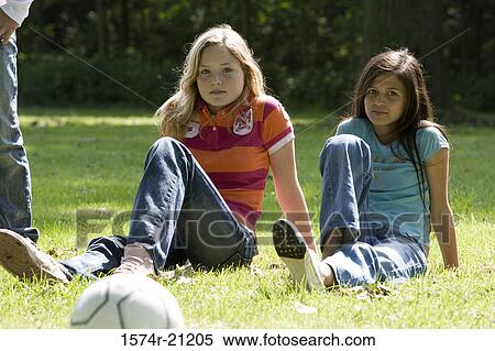 Portrait of two girls sitting in a park View Large Photo Image Stock Photography - Portrait of two girls sitting in a park. Fotosearch