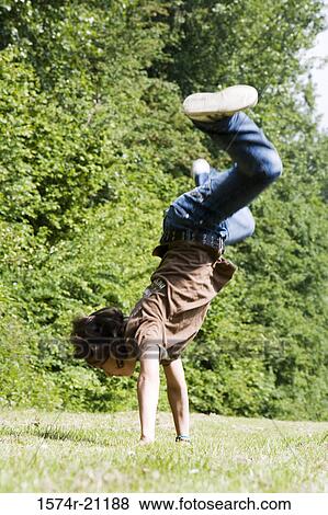 Side profile of a boy doing a handstand View Large Photo Image Stock Photo - Side profile of a boy doing a handstand. Fotosearch