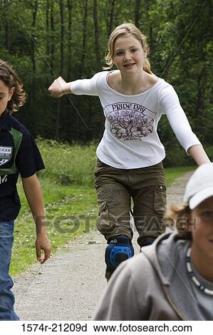 Two girls and a boy in a park View Large Photo Image Stock Image - Two girls and a boy in a park. Fotosearch