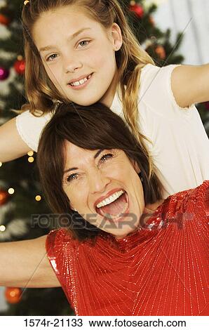 Stock Image - Close-up of a grandmother smiling with her granddaughter. Fotosearch