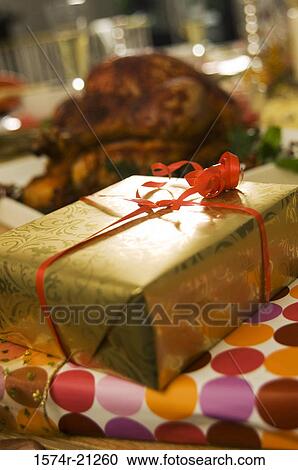 Close-up of two Christmas presents in front of a roasted turkey View Large Photo Image Stock Image - Close-up of two Christmas presents in front of a roasted turkey. Fotosearch