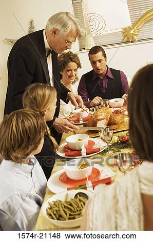 Family at a dining table View Large Photo Image Stock Photo - Family at a dining table. Fotosearch