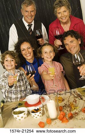 Portrait of a family smiling at a Christmas party View Large Photo Image Picture - Portrait of a family smiling at a Christmas party. Fotosearch