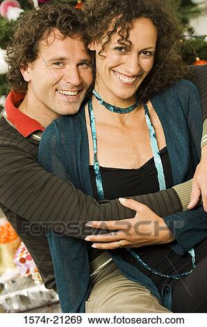 Portrait of a mid adult man embracing a mid adult woman from behind View Large Photo Image Stock Photo - Portrait of a mid adult man embracing a mid adult woman from behind. Fotosearch