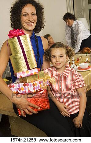 Stock Photo - Portrait of a mid adult woman smiling with her daughter. Fotosearch