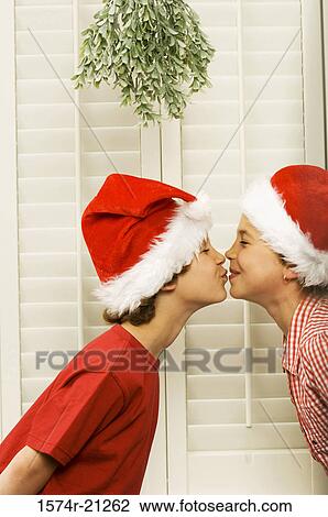 Side profile of a boy and girl kissing each other View Large Photo Image Stock Image - Side profile of a boy and girl kissing each other. Fotosearch
