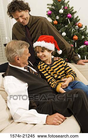 Side profile of a senior man with his son and grandson sitting on a couch View Large Photo Image Stock Photography - Side profile of a senior man with his son and grandson sitting on a couch. Fotosearch