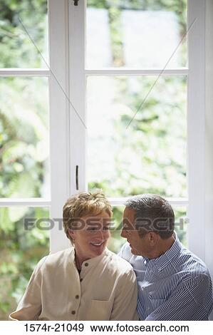 Stock Photo - Close-up of a mature couple smiling at each other. Fotosearch
