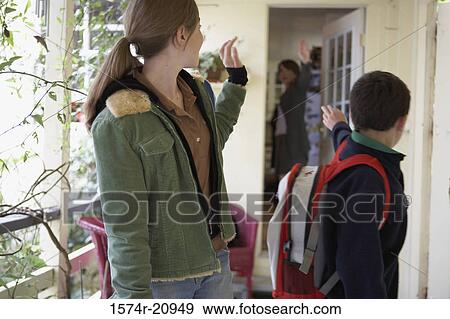 Close-up of a teenage girl and her brother waving at their mother while going to school View Large Photo Image Stock Photo - Close-up of a teenage girl and her brother waving at their mother while going to school. Fotosearch