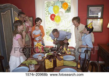 Stock Image - Family at a birthday party. Fotosearch