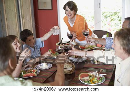 High angle view of a family toasting with glasses at a dining table View Large Photo Image Stock Photo - High angle view of a family toasting with glasses at a dining table. Fotosearch