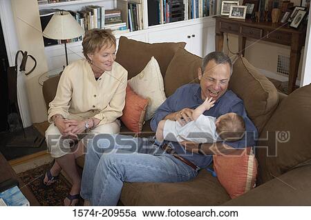 High angle view of a mature couple cuddling their grandson View Large Photo Image Stock Image - High angle view of a mature couple cuddling their grandson. Fotosearch