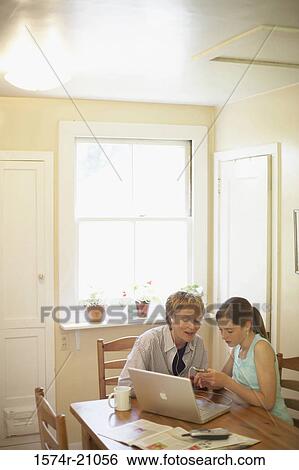 High angle view of a teenage girl and her grandmother looking at an MP3 player View Large Photo Image Stock Photograph - High angle view of a teenage girl and her grandmother looking at an MP3 player. Fotosearch