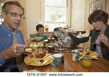 Mid adult couple having breakfast with their two sons View Large Photo Image Stock Photo - Mid adult couple having breakfast with their two sons. Fotosearch