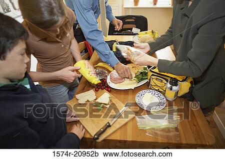 Stock Image - Mid section view of a mid adult couple with their son and daughter at a breakfast table. Fotosearch