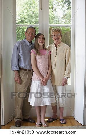 Portrait of a mature couple standing with their granddaughter View Large Photo Image Stock Image - Portrait of a mature couple standing with their granddaughter. Fotosearch