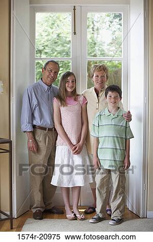 Portrait of a mature couple standing with their grandson and granddaughter View Large Photo Image Stock Photography - Portrait of a mature couple standing with their grandson and granddaughter. Fotosearch