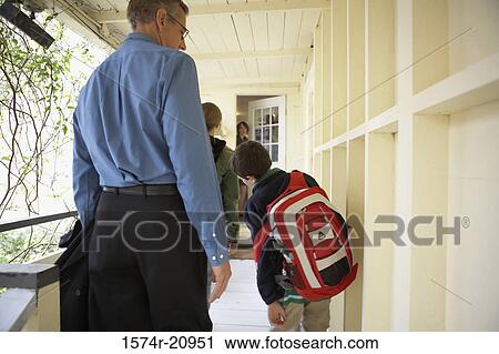 Rear view of a mid adult man with his daughter and son going to school View Large Photo Image Stock Image - Rear view of a mid adult man with his daughter and son going to school. Fotosearch