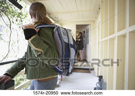 Side profile of a teenage girl going to school with her mother standing at the door View Large Photo Image Stock Image - Side profile of a teenage girl going to school with her mother standing at the door. Fotosearch