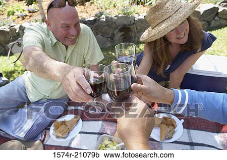 Close-up of a mature couple and their friends toasting with wineglasses View Large Photo Image Stock Image - Close-up of a mature couple and their friends toasting with wineglasses. Fotosearch
