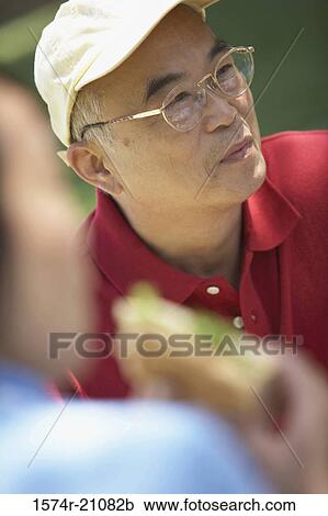 Stock Image - Close-up of a mature man in front of a mature woman. Fotosearch