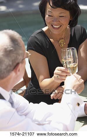 Close-up of a mature woman and a mature man toasting with champagne flutes View Large Photo Image Stock Photo - Close-up of a mature woman and a mature man toasting with champagne flutes. Fotosearch