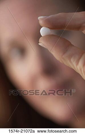 Close-up of a mature woman showing a pill View Large Photo Image Stock Image - Close-up of a mature woman showing a pill. Fotosearch