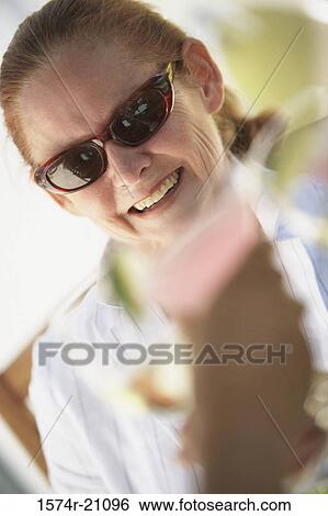 Close-up of a mature woman smiling View Large Photo Image Stock Photograph - Close-up of a mature woman smiling. Fotosearch