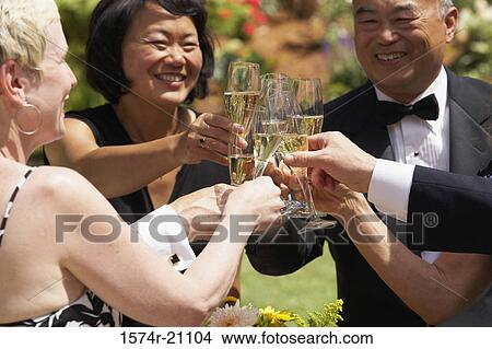 Close-up of mature couples toasting with champagne flutes View Large Photo Image Picture - Close-up of mature couples toasting with champagne flutes. Fotosearch