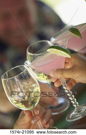 Close-up of three people's hands toasting with glasses View Large Photo Image Stock Photography - Close-up of three people's hands toasting with glasses. Fotosearch