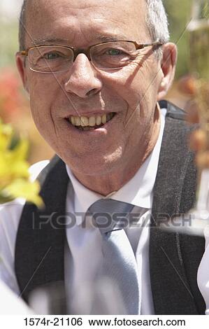 Portrait of a mature man smiling View Large Photo Image Stock Photograph - Portrait of a mature man smiling. Fotosearch