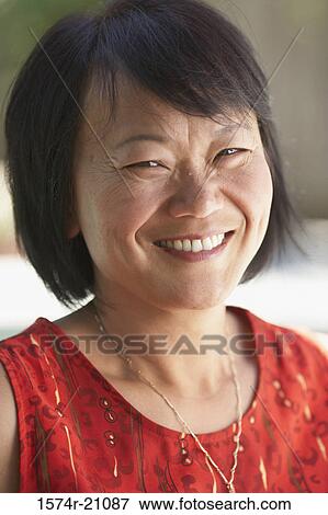 Portrait of a mature woman smiling View Large Photo Image Stock Photo - Portrait of a mature woman smiling. Fotosearch