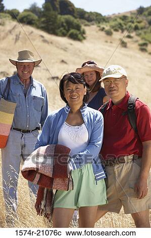 Portrait of two mature couples standing in a field View Large Photo Image Stock Image - Portrait of two mature couples standing in a field. Fotosearch